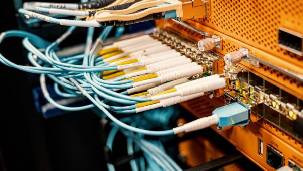 Modern hardware and structured cabling system with patch cords inserted into patch panel outlets
