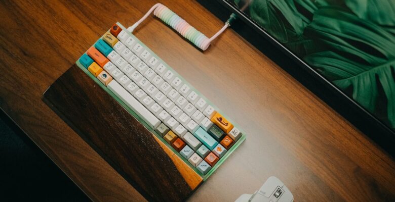 Stylish mechanical keyboard with colorful keycaps on wood desk, vibrant workspace.